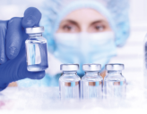 Laboratory assistant places something in a medical refrigerator