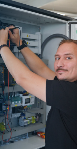 Riedel Kooling service employee, Glen Dimplex Precision Cooling, working on a chiller control cabinet