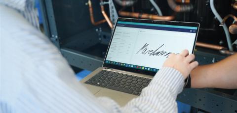 Customer signs service order on a tablet