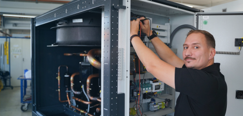 Riedel Kooling service employee, Glen Dimplex Precision Cooling, working on a chiller control cabinet